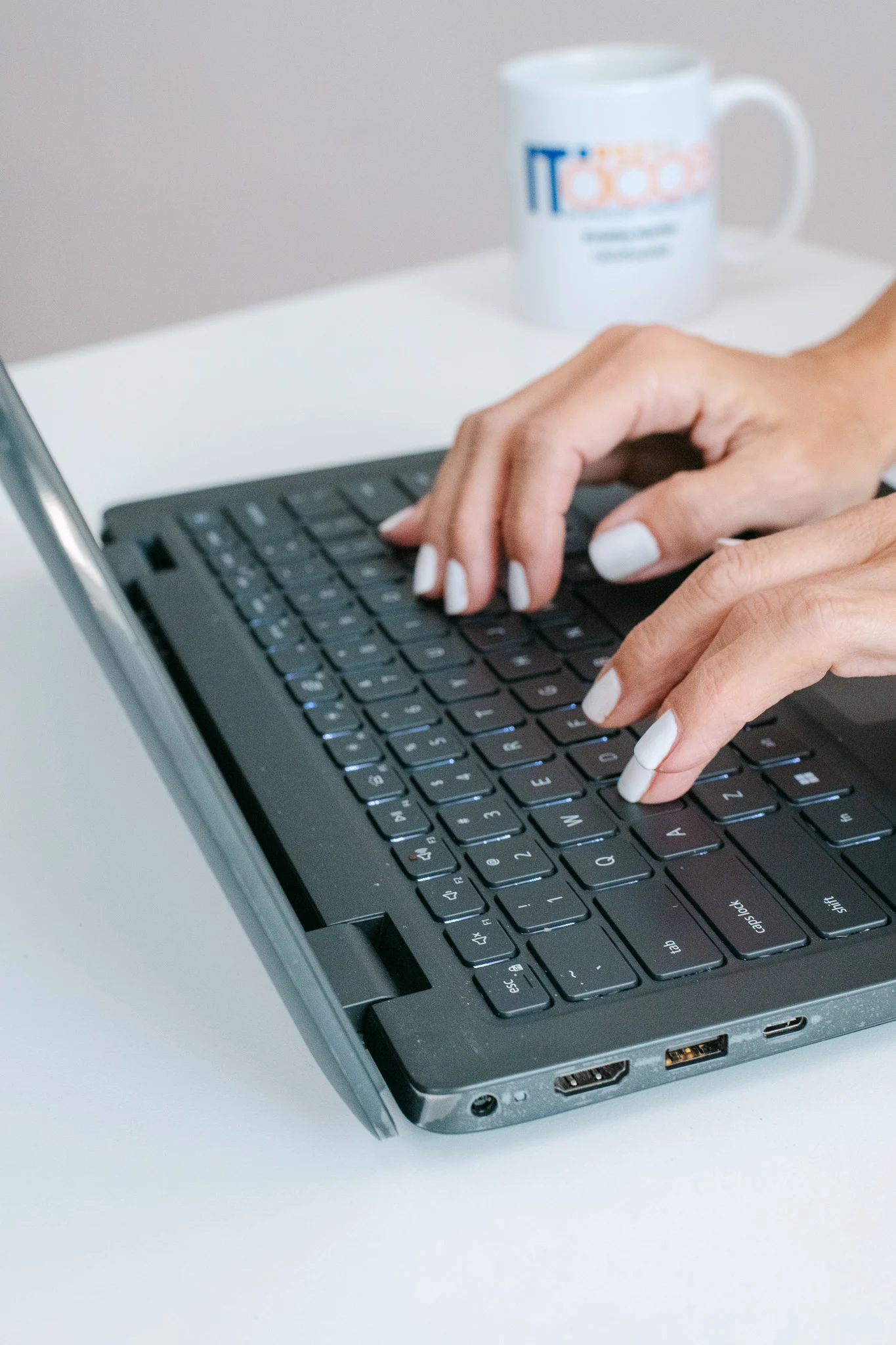 Person typing on a laptop keyboard, working on engineering and infrastructure projects