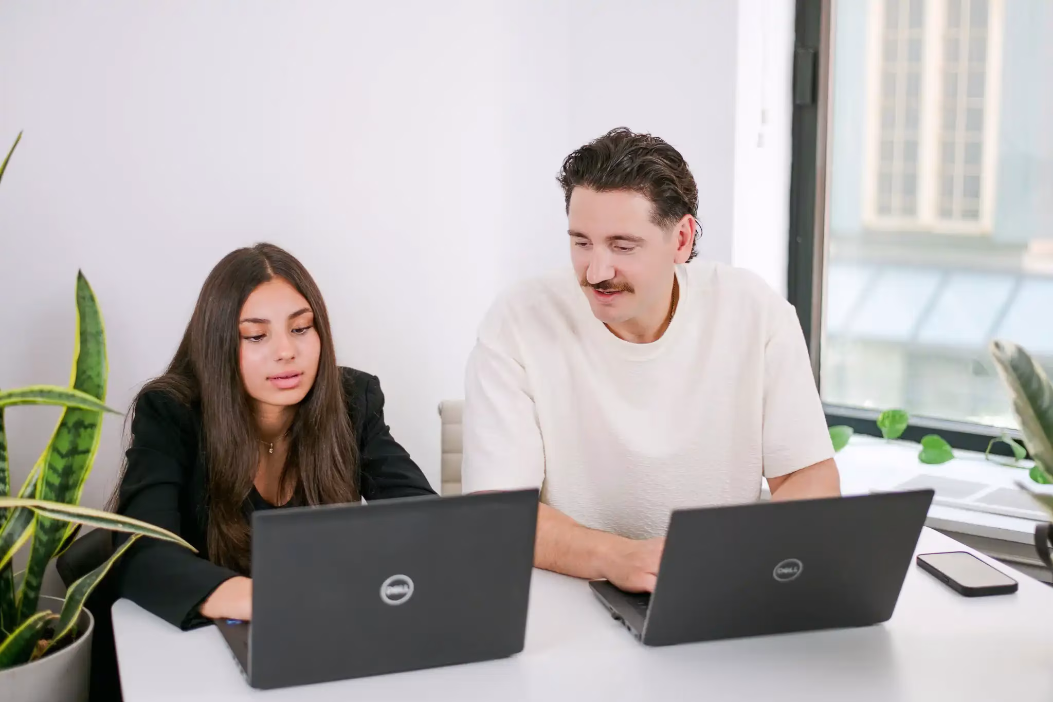 Recruiter and candidate reviewing contract-to-hire opportunities together on laptops